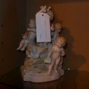 A Continental porcelain figure group of four cherubs heightened in gilt