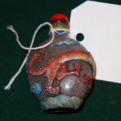 A Chinese Peking glass snuff bottle decorated with a dragon