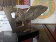 A bronze Bentley car mascot model on green marble base