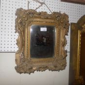 A C19th looking glass the bevelled plate in an acanthus leaf decorated frame