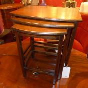 An oak nest of three tables on stretchered supports