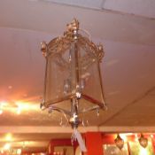 A pair of chrome hanging lanterns with glazed bevelled panels of graduating size