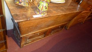 An old pine dough bin with lid and raised on stand