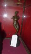 An Art Deco style bronze of a female dancer raised on black marble pedestal base
