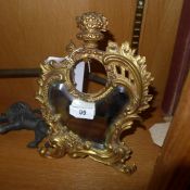A collection of gilt metal frames and a dressing mirror with clock aperture