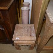 two rouge marble columns and a limed teak plant stand