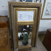 A gilt wall hanging mirror with cherub plaque inset