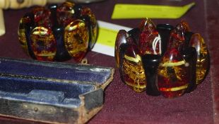 A pair of faux amber bracelets with insect insets