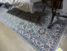 A large hand knotted Persian carpet with floral design on green field