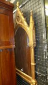 A Gothic influence gilded wall mirror with carved finial