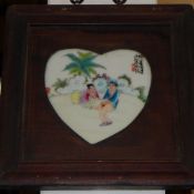 A pair of erotic plaques with heart shaped centre