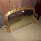 A C19th giltwood overmantle mirror with arched plate having carved acanthus relief