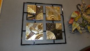 A collection of four painted metal plaques