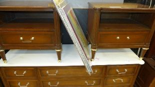 A pair of matching bedside tables