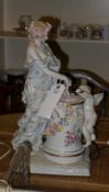 A Meissen style figure group of a lady and a cherub playing a drum