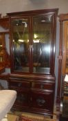 A Chinese style bookcase with glazed doors over two drawers and panels (no shelves)