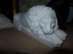 A pair of recumbent marble lions on stand
