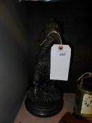 A bronze cast of a bear eating fruit