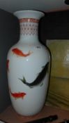 A pair of ceramic vases with fish decoration