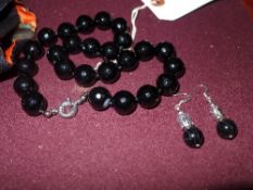 A faceted agate necklace with earrings. 16mm beads