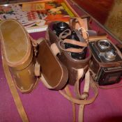 A Zeiss Ikon camera together with a pair of Ross binoculars and a French pair of binoculars