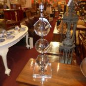 A pair of contemporary glass table lamps of globular form on square bases