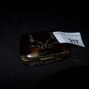 A tortoiseshell and inlaid purse with snakeskin detail