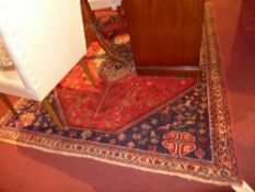 A Persian Abadell rug with central pendant medallion on a terracotta field in geometric border