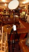 A floor standing theatre light on tripod supports