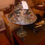 A Tiffany style stained and leaded glass table lamp decorated with butterflies