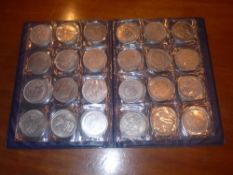 A collection of various white metal replica coins