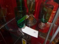 A set of three green drinking glasses
