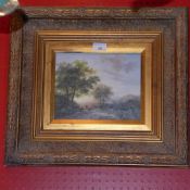 An oil on panel landscape scene signed Robert Driscoll in a gilded frame