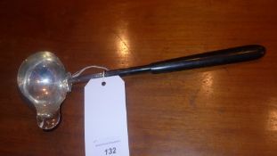 A silver punch laddle