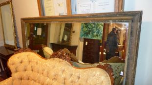 A C19th mirror of large size the rectangular plate within giltwood and gesso frame