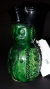 A  C1900 Belgian earthenware jug in the form of a millitary gentleman in a green glaze