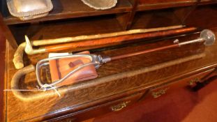 A collection of four various walking sticks one with a brass mallards head form handle together with