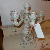 A Continental porcelain seven branch candelabra with figures and flowers encrusted decoration