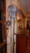 A good quality Mole Richardson brass and steel studio light on telescopic supports and raised on