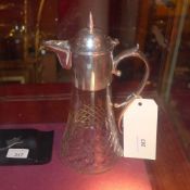 A silver plated and cut glass claret jug