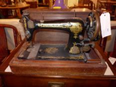 A Singer sewing machine in oak case