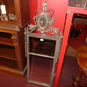 A pair of French style pier mirrors the rectangular bevelled plates within leafy ribbon gilt frames