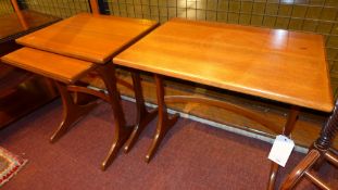 A nest of three teak low tables
