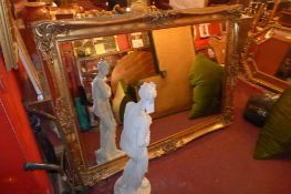 A wall mirror of large size the rectangular bevelled plate within swept gilt frame