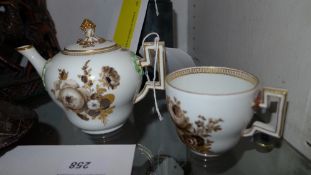 A C1790's Meissen porcelain bullet teapot decorated with hand painted flowers and highlighted with