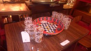 An American 1950's drink set comprising roulette wheel style tray and eight glasses
