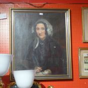 An 1848 oil on canvas portrait of a lady by Thomas Gregg signed to the letter held by the subject