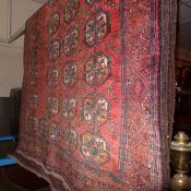 A fine North East Persian Turkoman rug 205 x 115 cm repeating goul motifs on a terracotta field