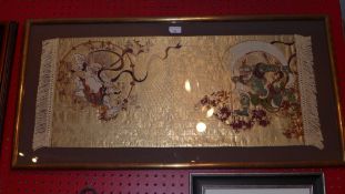 A Japanese embroided silkwork glazed and in gilt frame depicting demons