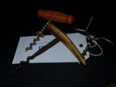 Three corkscrews including an erotic example a horn handled corkscrew and another
